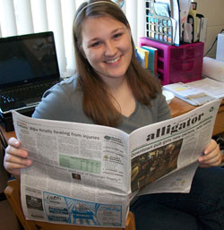 Dana reading the University of Florida school newspaper, the Alligator. Dana has had her work published in the Alligator as well.