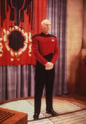 Picard standing before Q in effort to save the universe