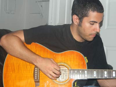Mike Llerena playing guitar