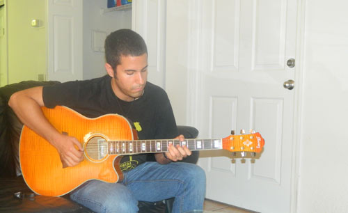 Mike Llerena playing guitar
